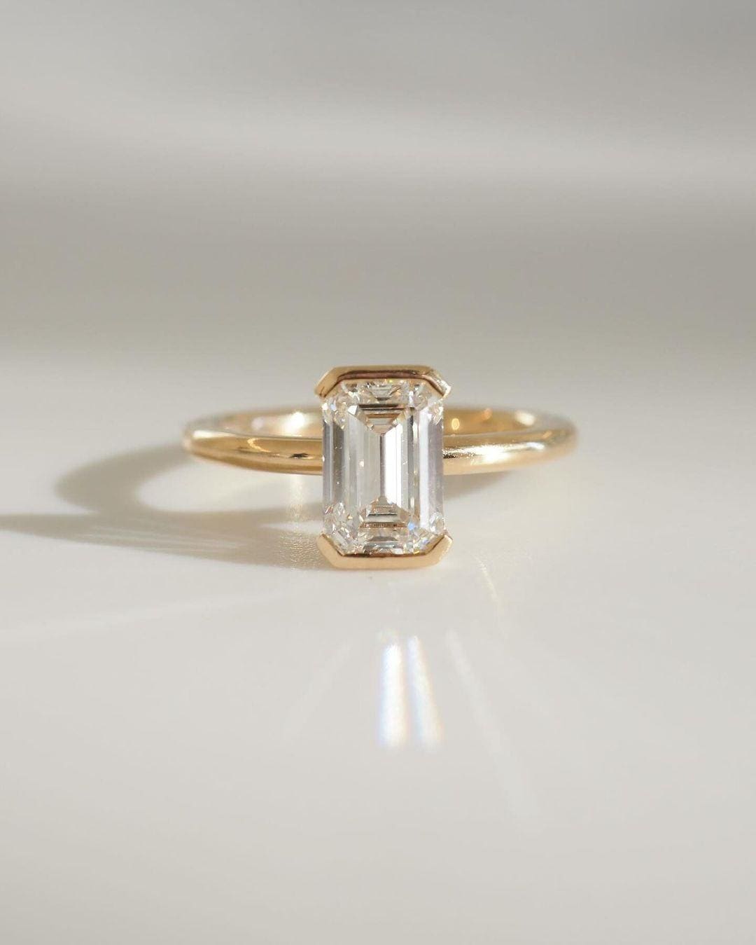 2.00CT Emerald Cut Lab Grown Diamond Ring: 14K Yellow Gold Half Bezel Set