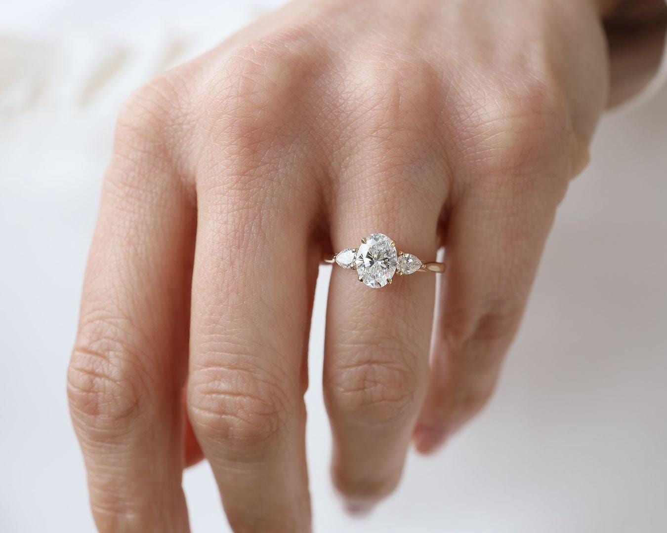 Oval Lab Grown Diamond Engagement Ring: Three Stone Pear Side Stones, Hammered Band