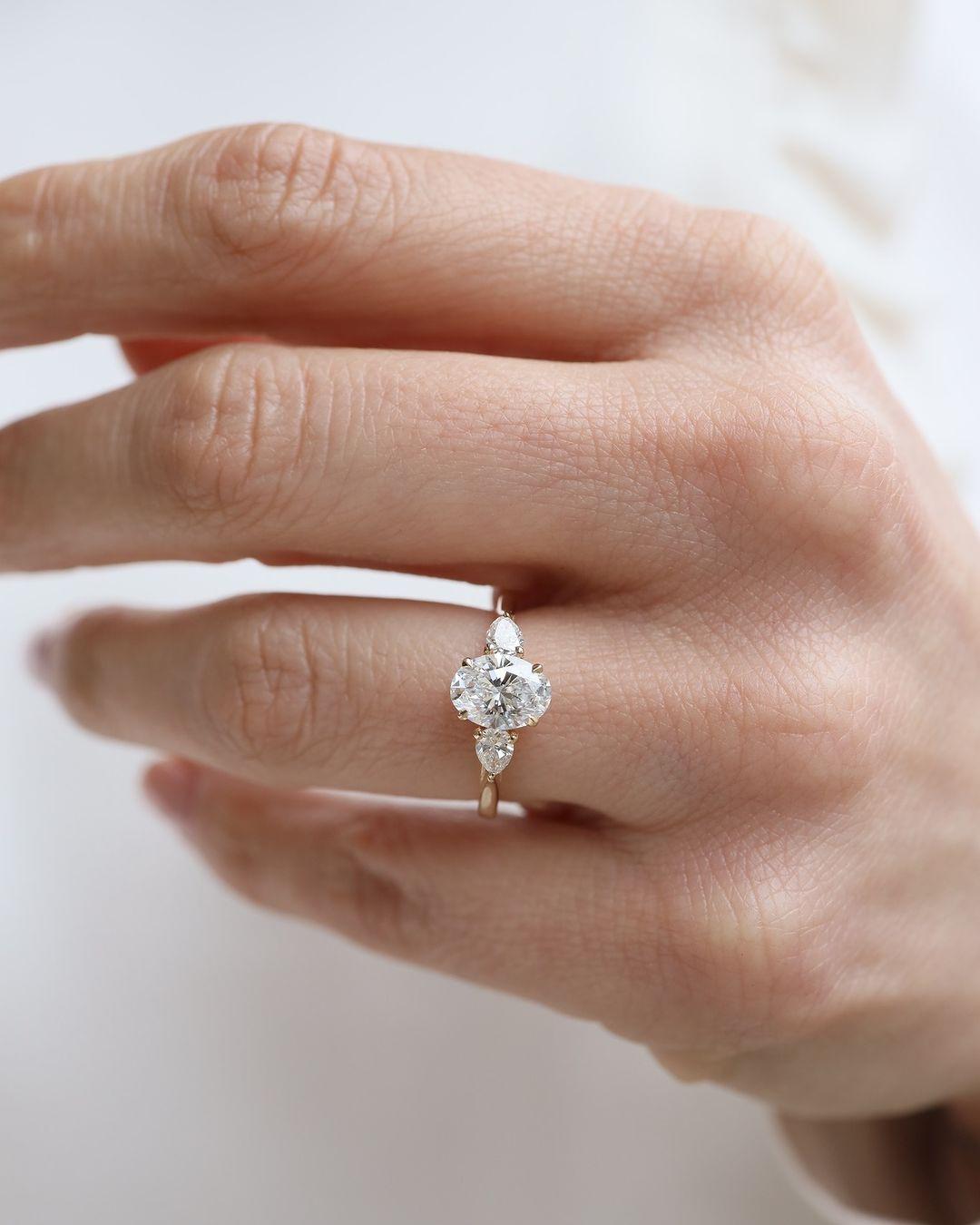 Oval Lab Grown Diamond Engagement Ring: Three Stone Pear Side Stones, Hammered Band